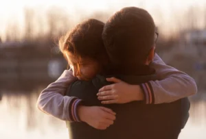 Father embracing daughter, symbolizing God’s perfect love.