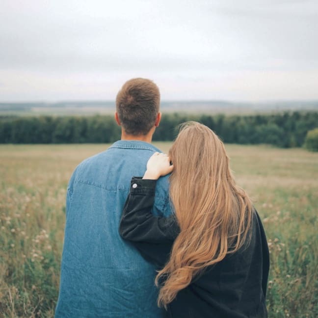 Couple embracing in a field, representing couples therapy sessions offered at arKardia in Gettysburg, PA.