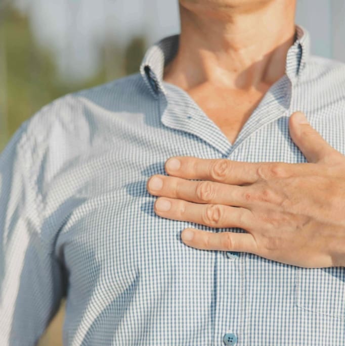 Hand resting over the heart, symbolizing the arKardia Method's focus on closing the gap between head and heart in therapy and healing retreats.