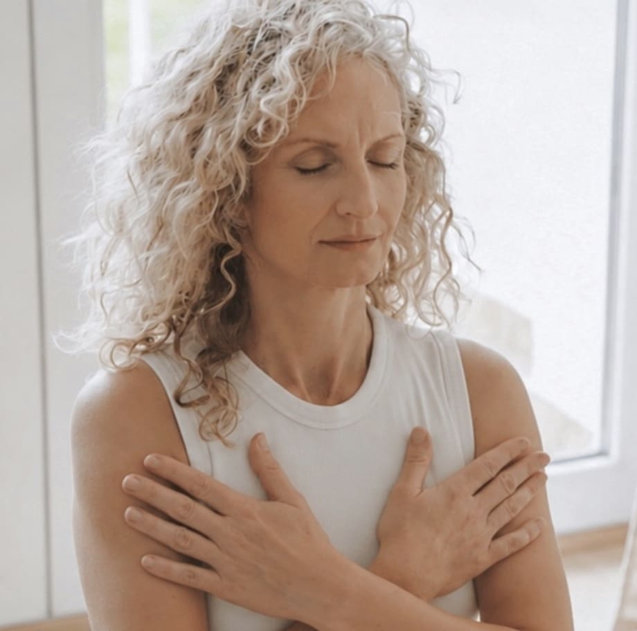 Woman with hands over her chest, representing EMDR therapy sessions offered at arKardia.