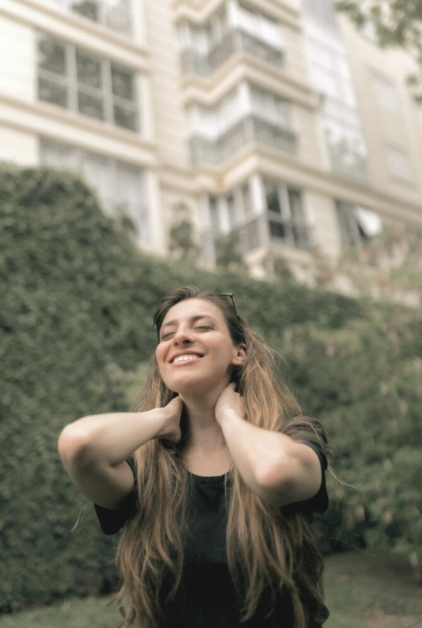 Woman smiling outdoors, representing the sense of relief and clarity clients experience after completing a therapy intensive at arKardia.