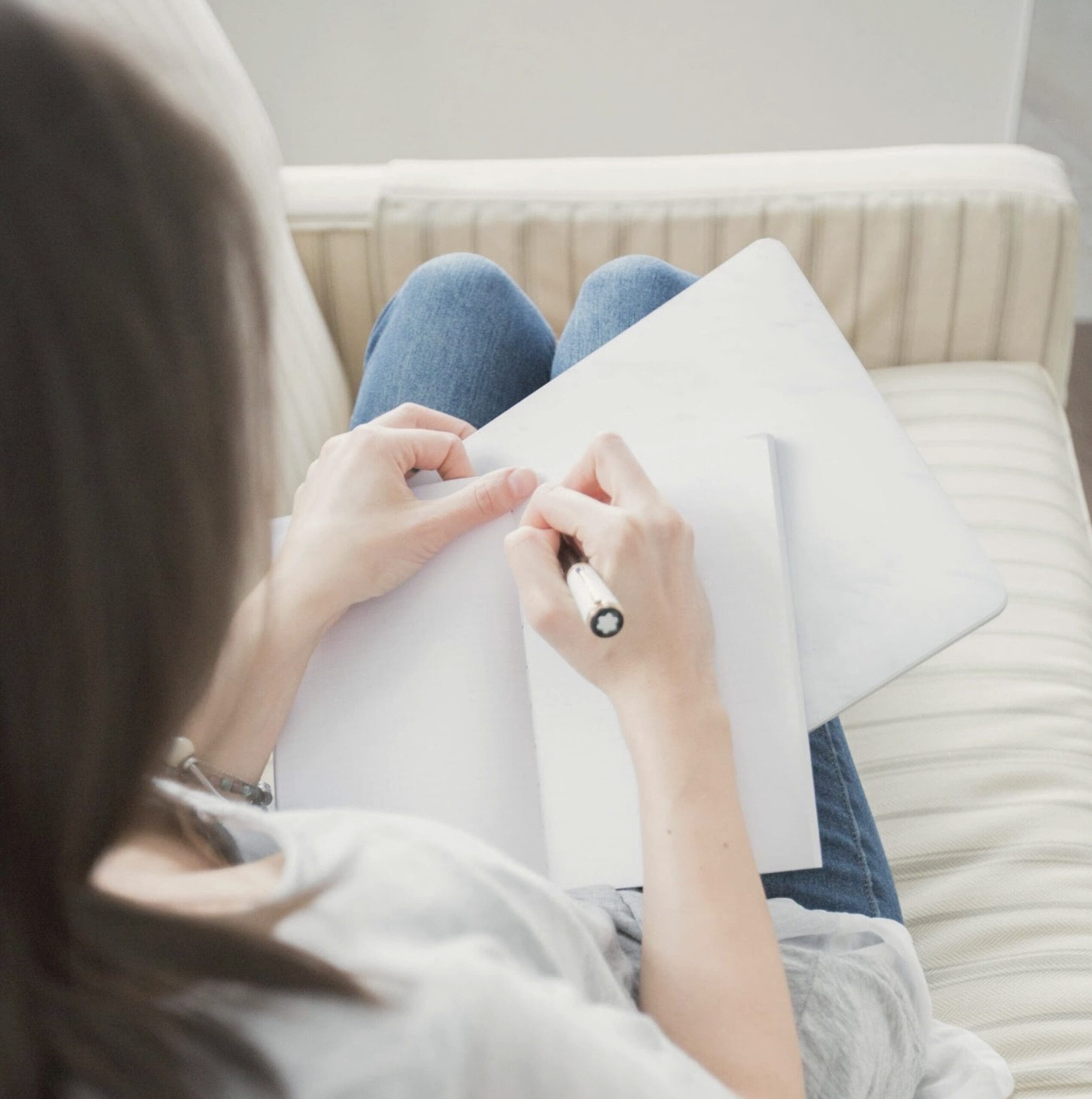 Woman journaling during a therapy intensive session, part of the extended, uninterrupted format arKardia offers.